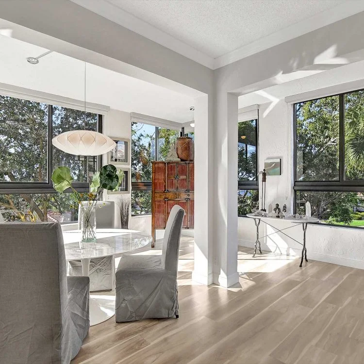 Dining table beside windows overlooking trees