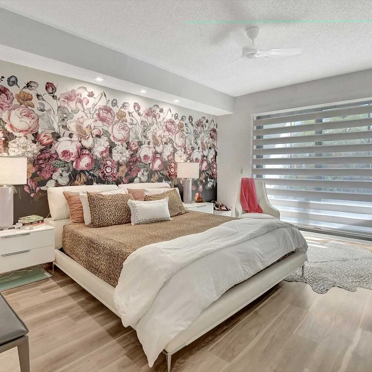 A restful bedroom framed by expressive floral wallpaper