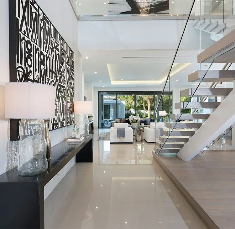 A sculptural staircase and patterned entry at Delray Modern by the Sea