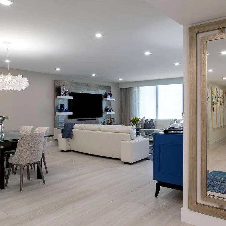 Open living and dining room with a blue entry cabinet