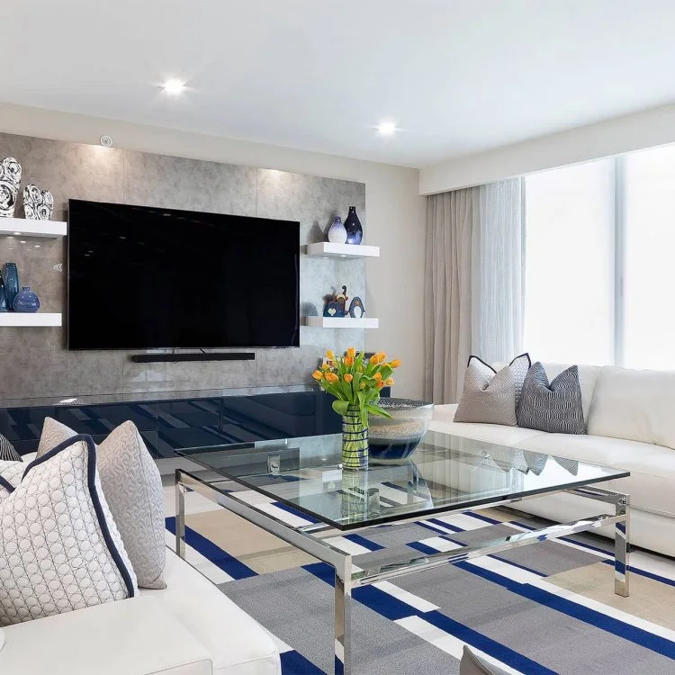 Living room television wall with display shelves and white seating