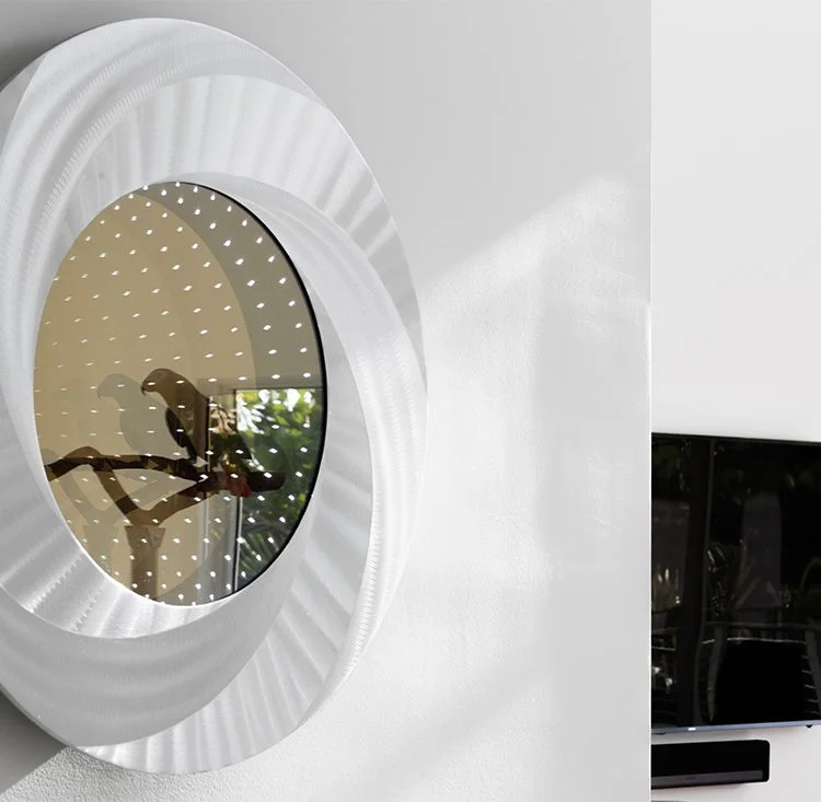 Sculptural circular mirror with a textured white frame