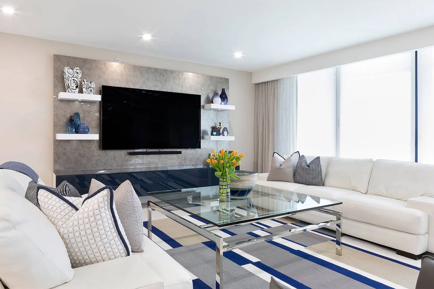 A family gathering room with soft seating and a glass coffee table