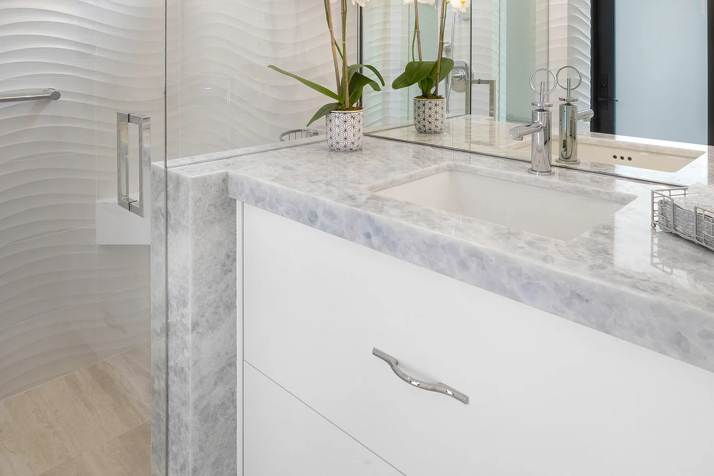 A serene bathroom with a stone vanity and textured walls