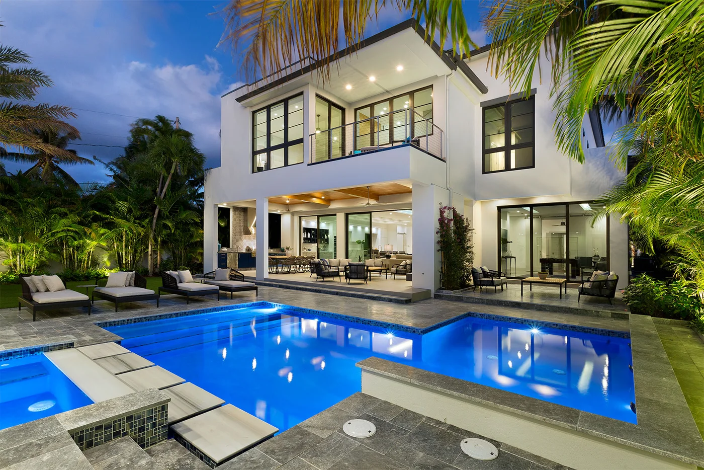 A South Florida home and swimming pool at dusk